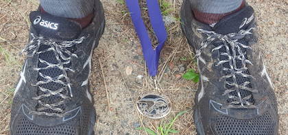 shoes, dirt, and medal