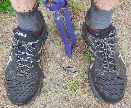 shoes, dirt, and medal